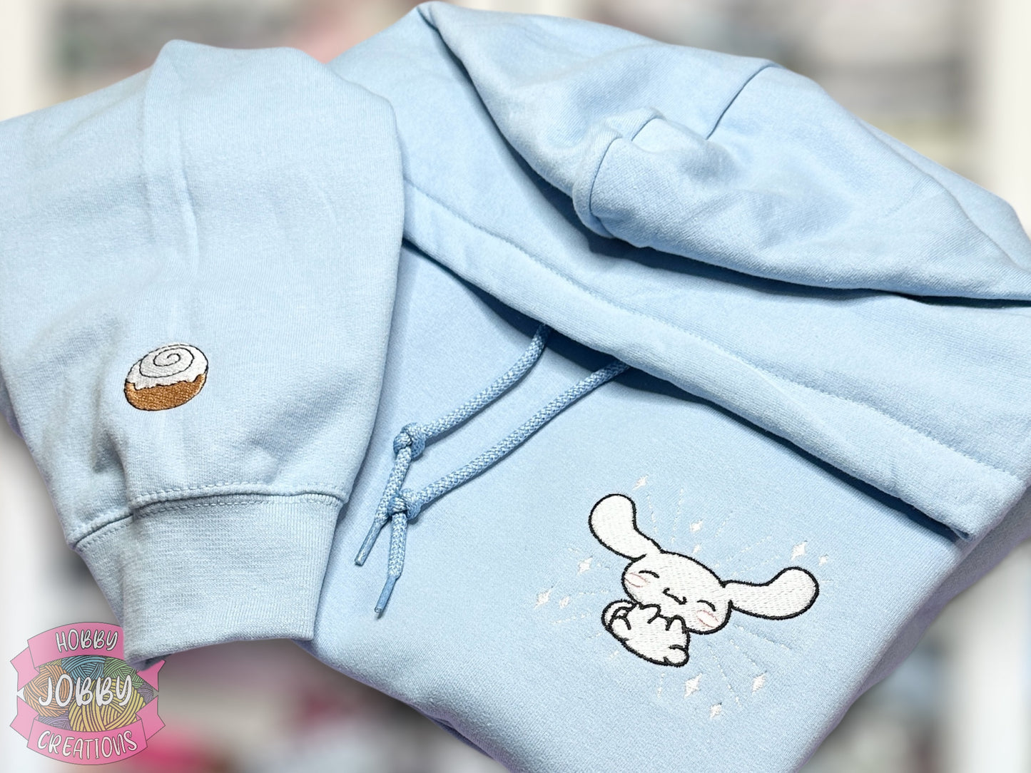 Flying Dog Friend Embroidered Hoodie with Cinnamon Roll Sleeve Embellishment